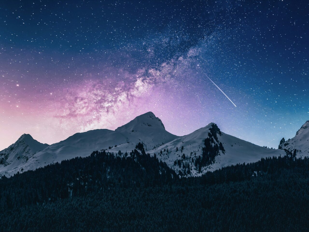 Mountain landscape under starry sky with Milky Way.