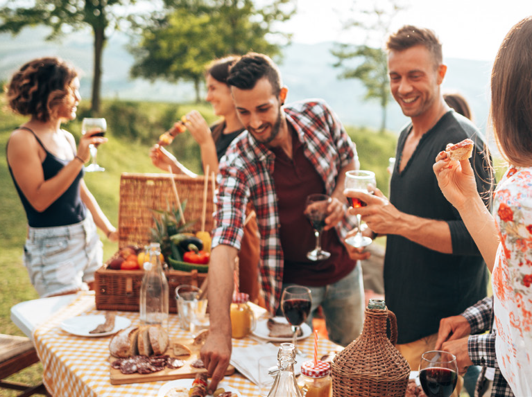 Group of friends gathering to eat lunch outside.