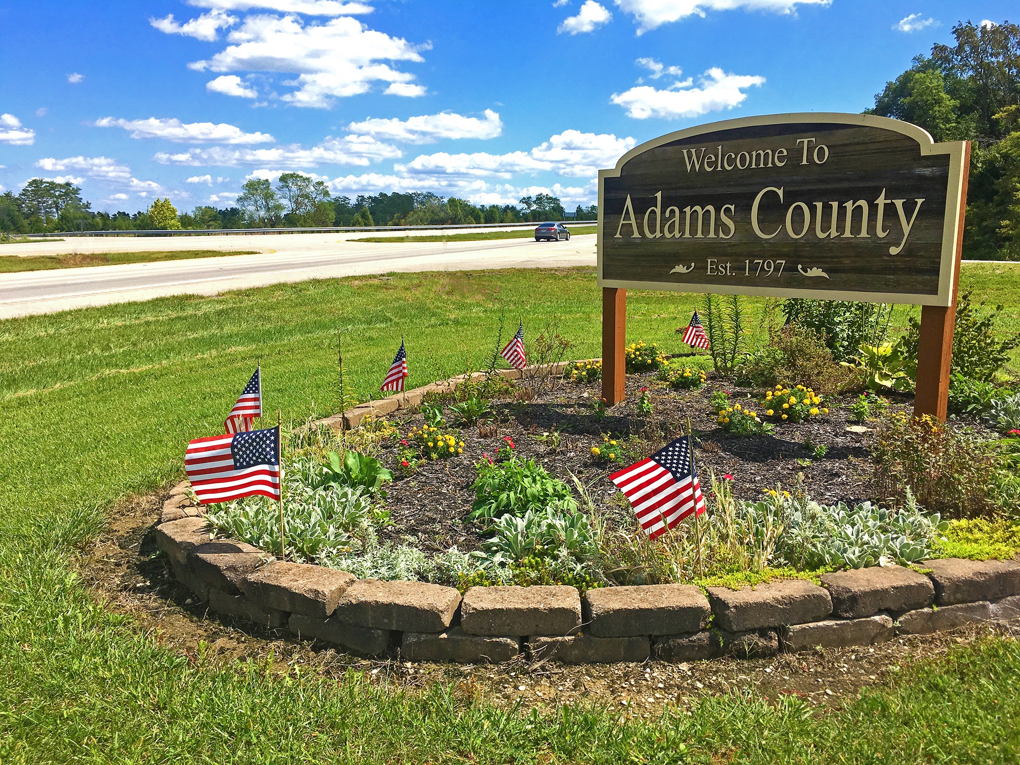 A welcome to Adams County sign.