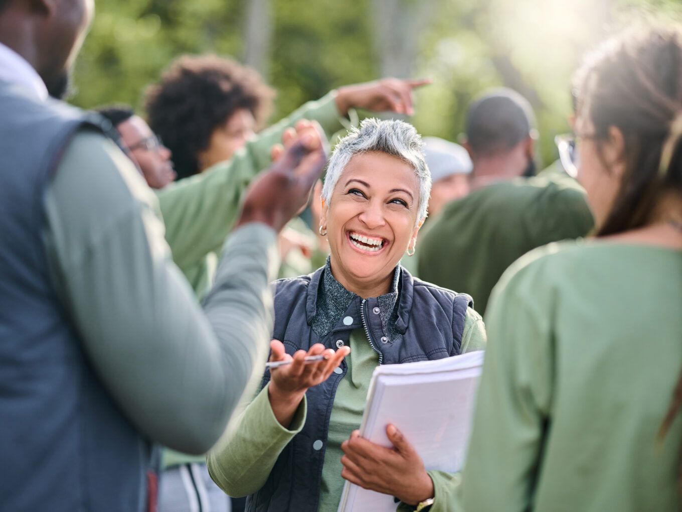 Volunteer, team and people in nature for community service, teamwork and planning with leadership, goals and strategy. Senior person or leader for management in forest, park or eco friendly project