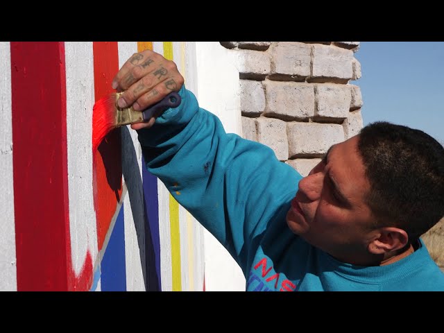 Man painting mural