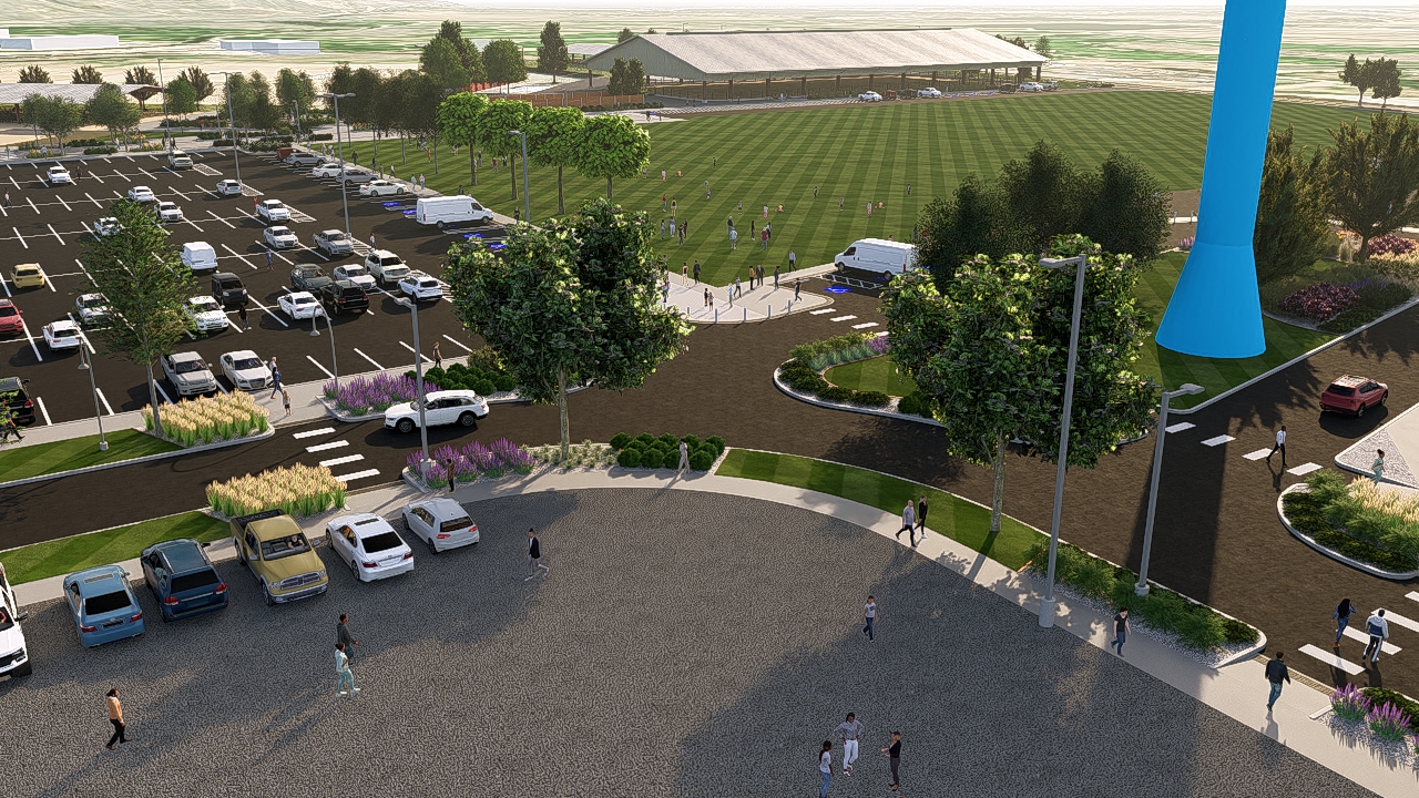 Parking lot with cars, people walking, landscaped area, visible sports field, and a large blue structure.