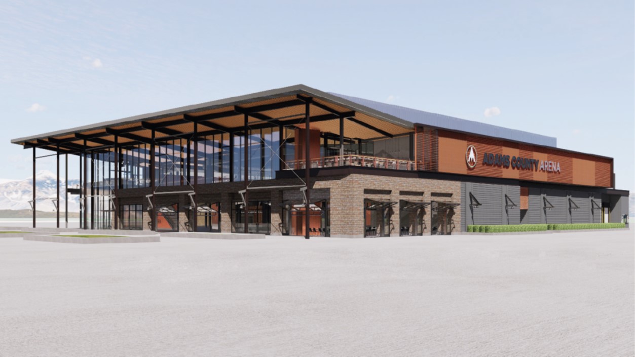 Adams County Arena exterior with large glass windows and brown accents, mountain backdrop