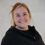Brittany smiling with light brown hair, wearing a black hoodie, against a neutral background