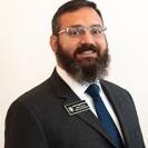 Josh Zygielbaum in a suit, smiling against a plain background.