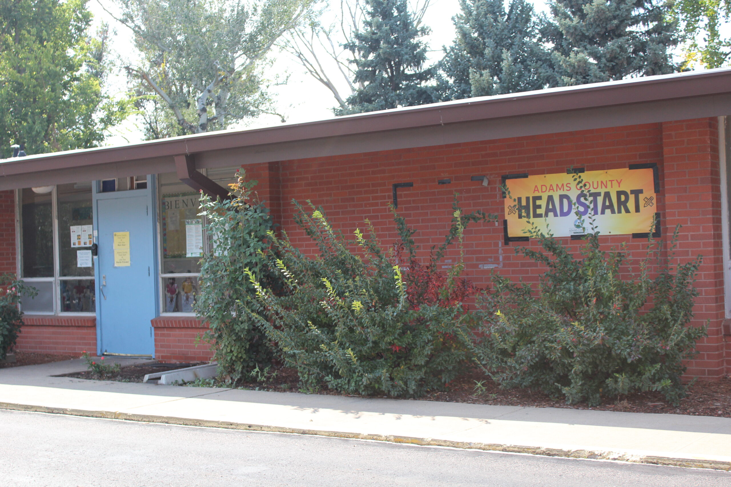 Adams County Head Start building with blue door and surrounding greenery
