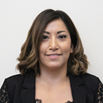 Liz Garcia smiling in a black jacket against a white background