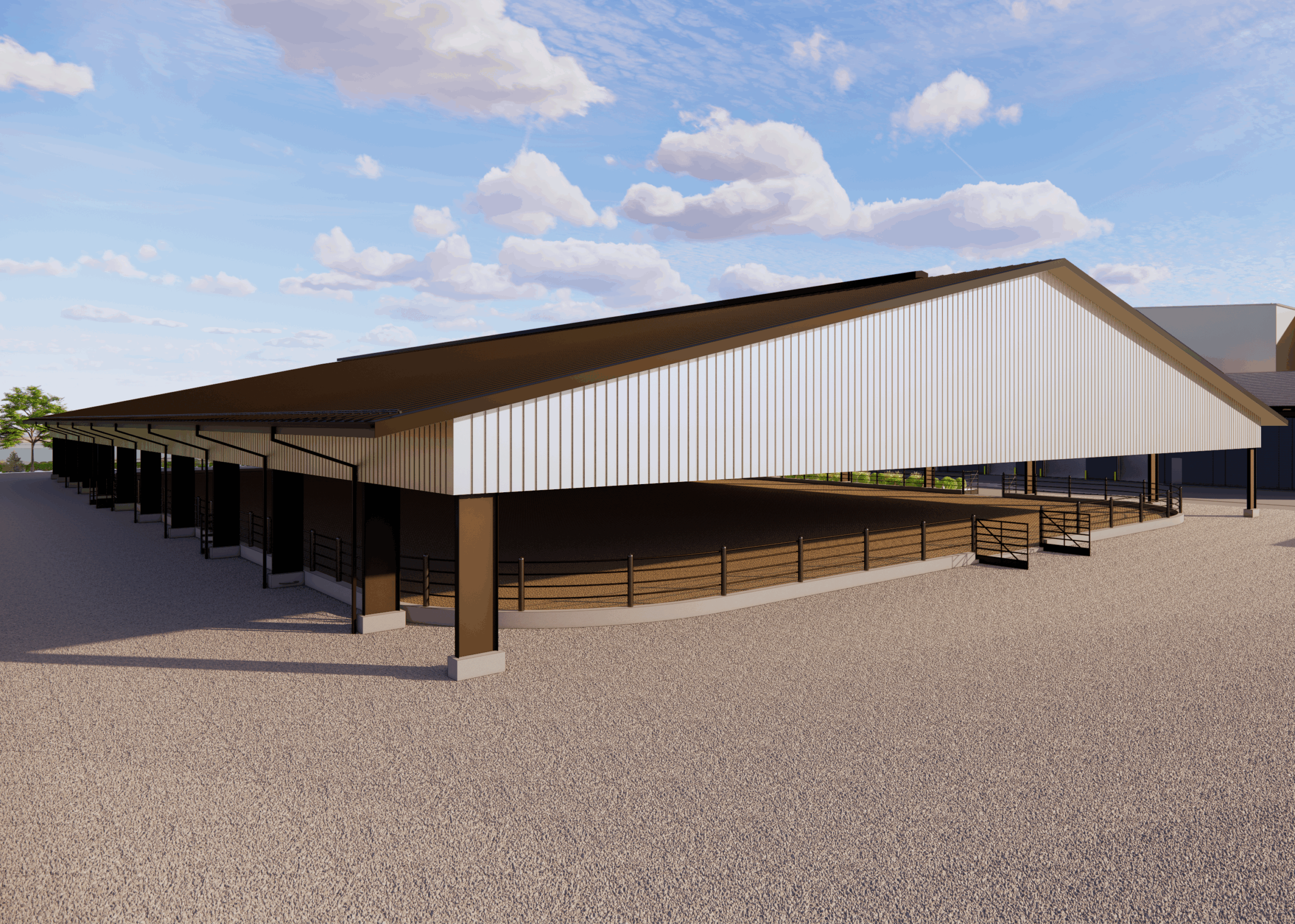 Large covered outdoor arena with metal roof, surrounded by fencing. Gravel path in the foreground under a blue sky with clouds