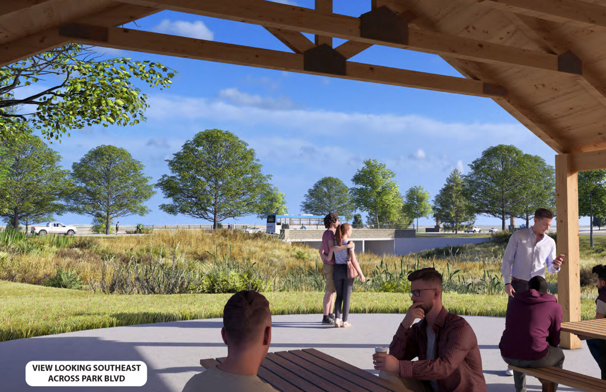 People relaxed at a pavilion, overlooking a vibrant park landscape.