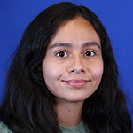 Rachel Rodriguez smiling with long dark hair and a blue background