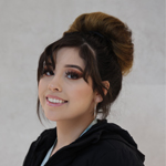 Steffanie Garcia smiling, wearing a black jacket and earrings.