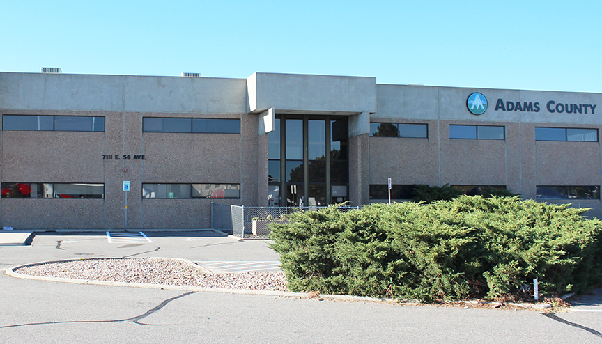 Adams County building, beige exterior, address 7111 E. 56 Ave.