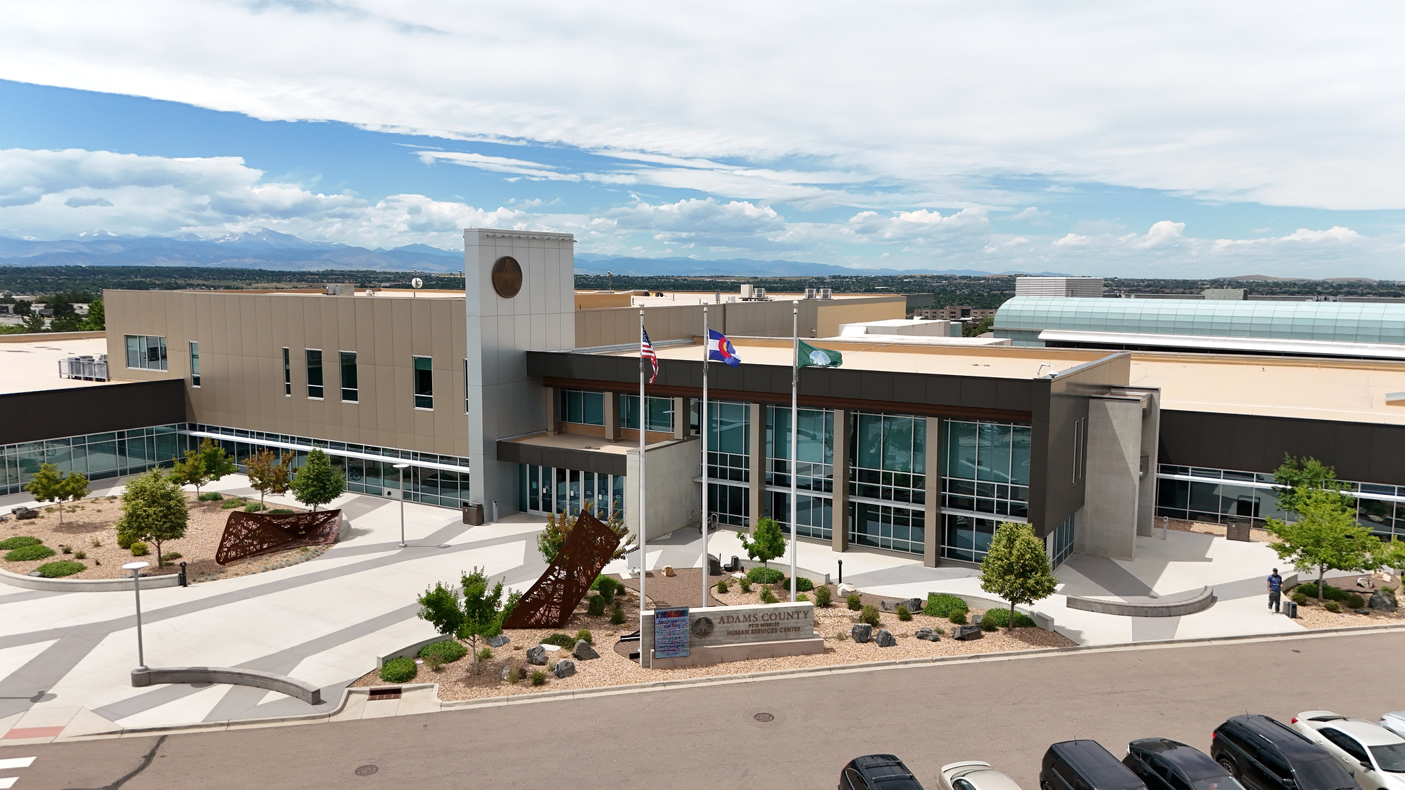 Adams County Human Services Center with flags and mountain view