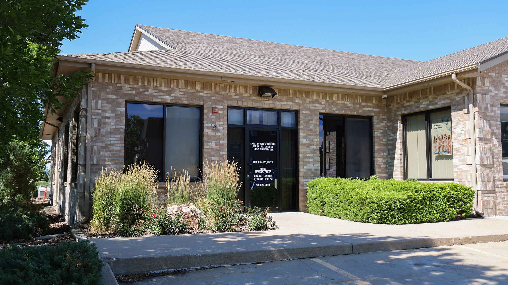 Adams County Workforce and Business Center entrance with shrubs and signage.