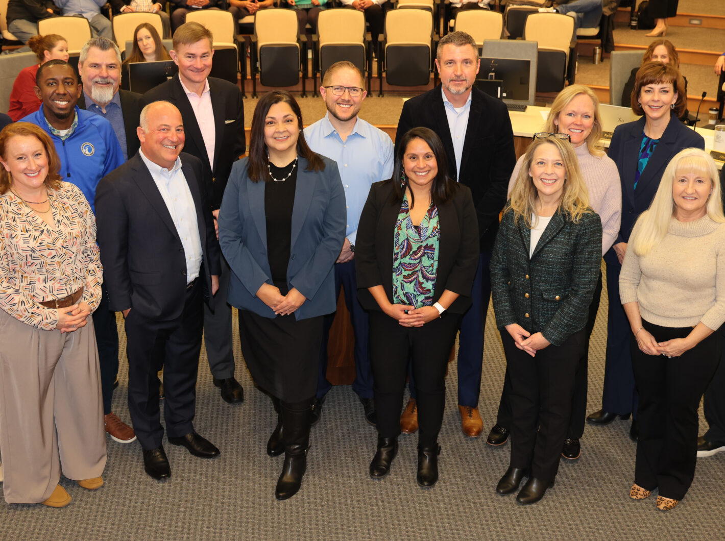 Group of 15 adults smiling in a formal setting, AltitudeX-Spaceport team.