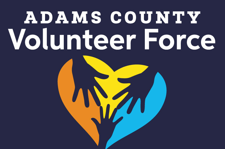 Adams County Volunteer Force logo, three hands form a multicolored heart, text: "Heart at Work!"