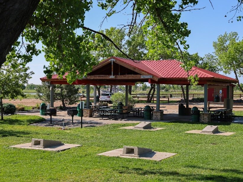Covered picnic area at Riverdale Regional Park under blue sky.